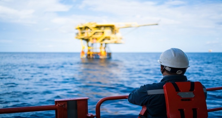 Picture of an oil worker and offshore oil rig
